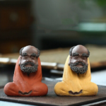 Handcrafted purple clay Bodhidharma zen tea pet main view, yellow color