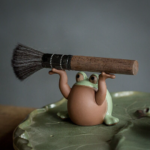 Handmade ceramic frog tea pet main view on green tea tray