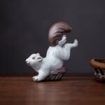 Main view of handcrafted ceramic squirrel tea pet on wood surface