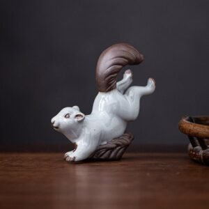 Main view of handcrafted ceramic squirrel tea pet on wood surface