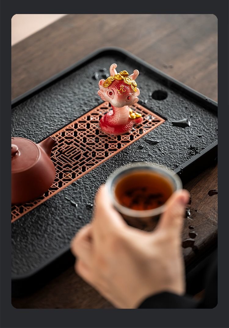 Red-white gradient color changing snake tea pet on tea tray with teapot and teacup