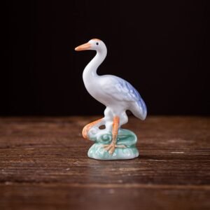 Main view of handcrafted porcelain crane tea pet with white body and blue gradient wings