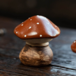 Main view of handcrafted purple clay mushroom tea pet with red spotted cap