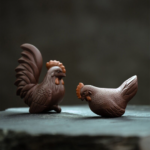 Main view of 2-piece handcrafted purple clay rooster and hen tea pet set