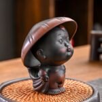 Funny sprinkling little monk ceramic tea pet with tea strainer holder on wooden tea table