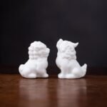 Main view of handcrafted white ceramic lucky lion tea pet on wooden table