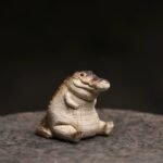 Yixing purple clay cute crocodile tea pet main view on stone display surface