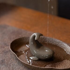Main view of handcrafted Yixing purple clay whale tea pet placed on wooden tea tray