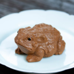 Handmade Yixing zisha golden toad tea pet main product view on wooden tea table
