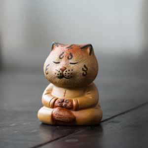 Handcrafted ceramic zen tiger tea pet main view on dark wooden tea tray