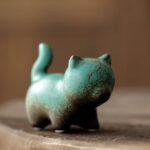 Front view of turquoise crackle glaze zisha cat tea pet showing vintage texture