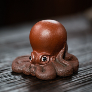 Handmade Yixing zisha octopus tea pet main product view on dark wooden tea tray