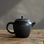 full view of 160ml textured black porcelain teapot with infuser