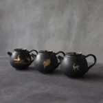 full view of 180ml matte black ceramic tea infuser pot with gold pattern