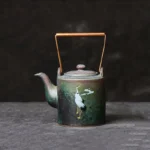 front view of 180ml vintage crane cloud ceramic teapot with copper handle