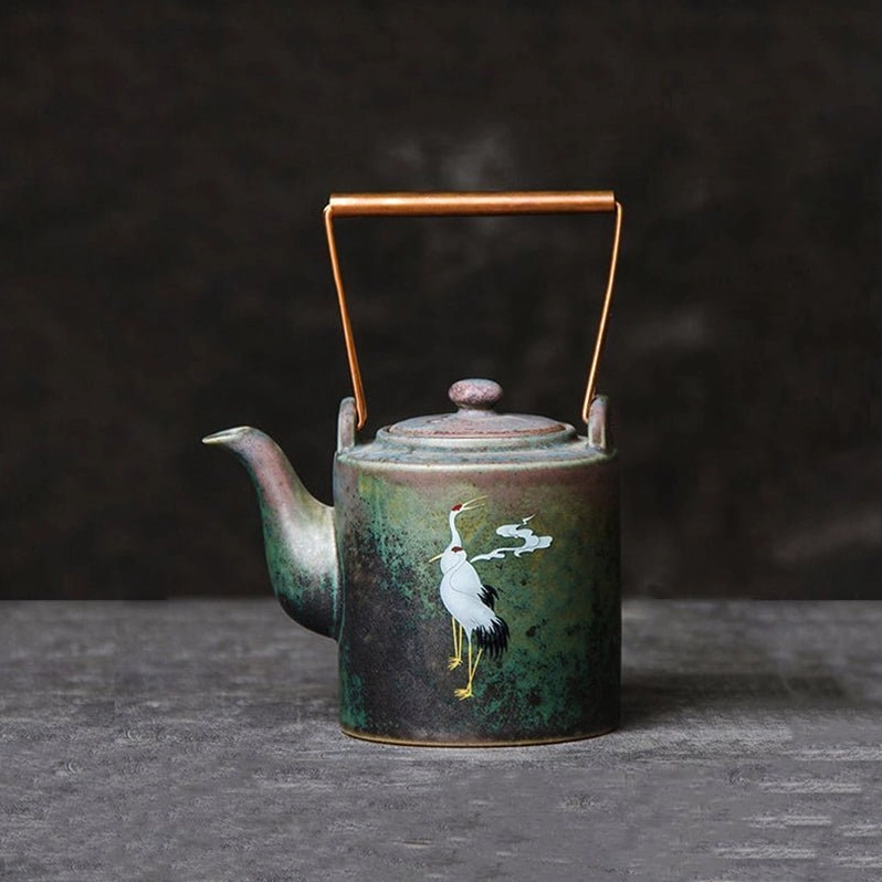 front view of 180ml vintage crane cloud ceramic teapot with copper handle
