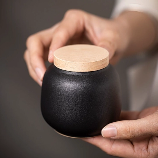 220ml sealed tea jar standing on natural wood background