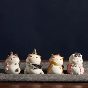 Full set of 4 cute Chinese imperial cat resin figurines displayed on a grey table