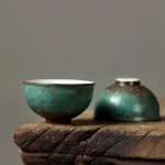 Close up front view of handmade antique green ceramic chawan tea bowl