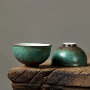 Close up front view of handmade antique green ceramic chawan tea bowl
