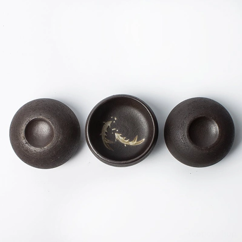 close up of rustic texture on black ceramic tea cup