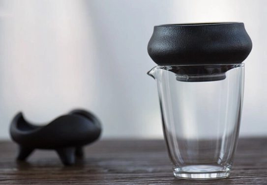 angled view of complete matte black ceramic loose leaf tea strainer set