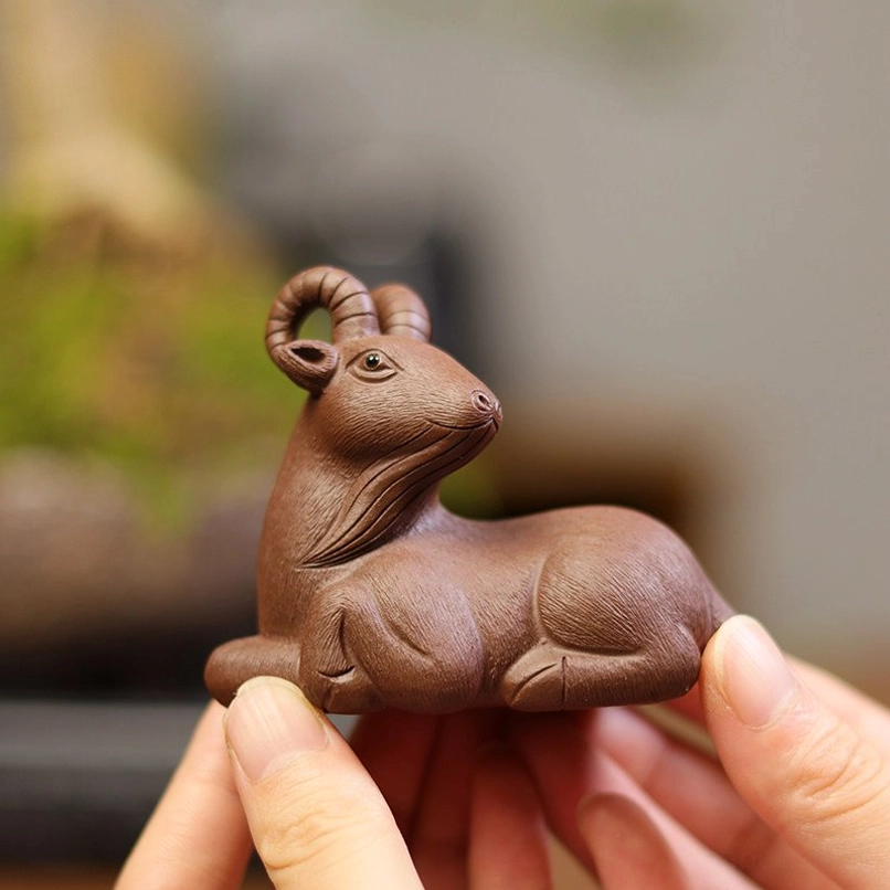 side angle view of authentic zisha goat tea pet gongfu tea accessory