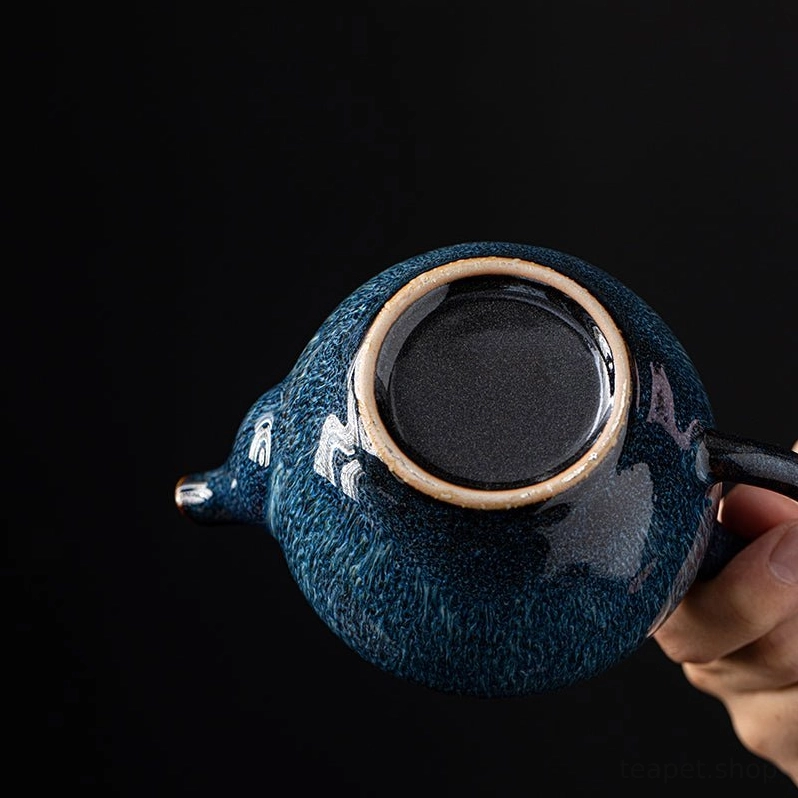 close up internal view of multi-hole filter of blue ceramic teapot