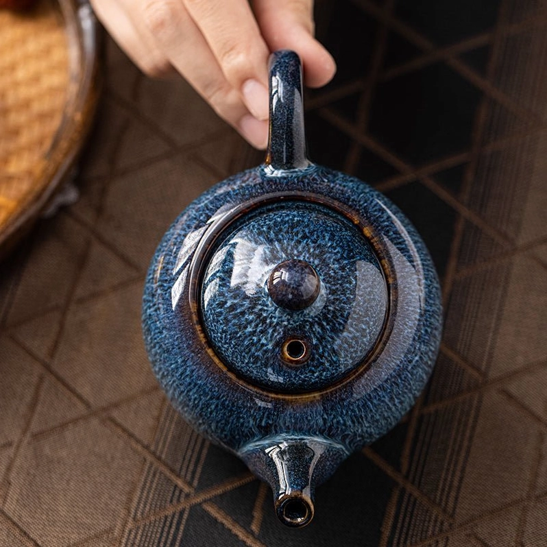 lid and knob of blue ceramic teapot close up view