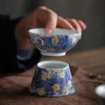 full set blue white ceramic loose leaf tea strainer with holder on wooden tea table