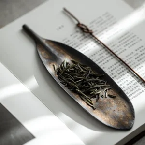 handmade bodhi leaf ceramic tea scoop on wooden tea table