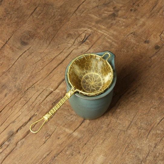 handmade brass loose leaf tea strainer top view of mesh basket