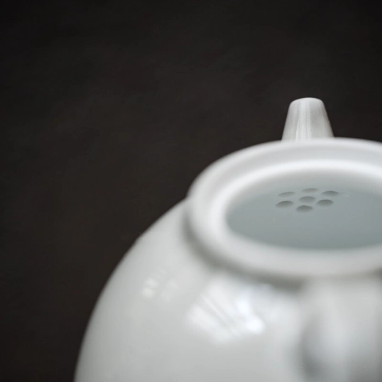 close up of built-in filter holes inside the celadon teapot mouth