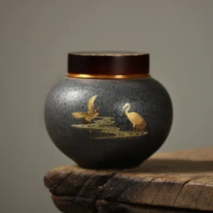 Full view of dark gray ceramic golden crane airtight tea jar