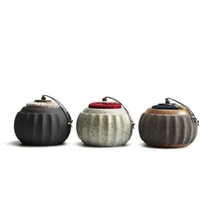 full set view of four styles handmade ceramic pumpkin tea jar