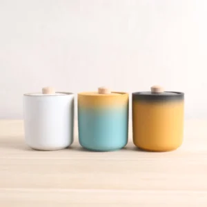 front view of gradient yellow blue ceramic airtight tea jar with wood handle