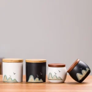 black ceramic tea jar with bamboo lid and landscape pattern