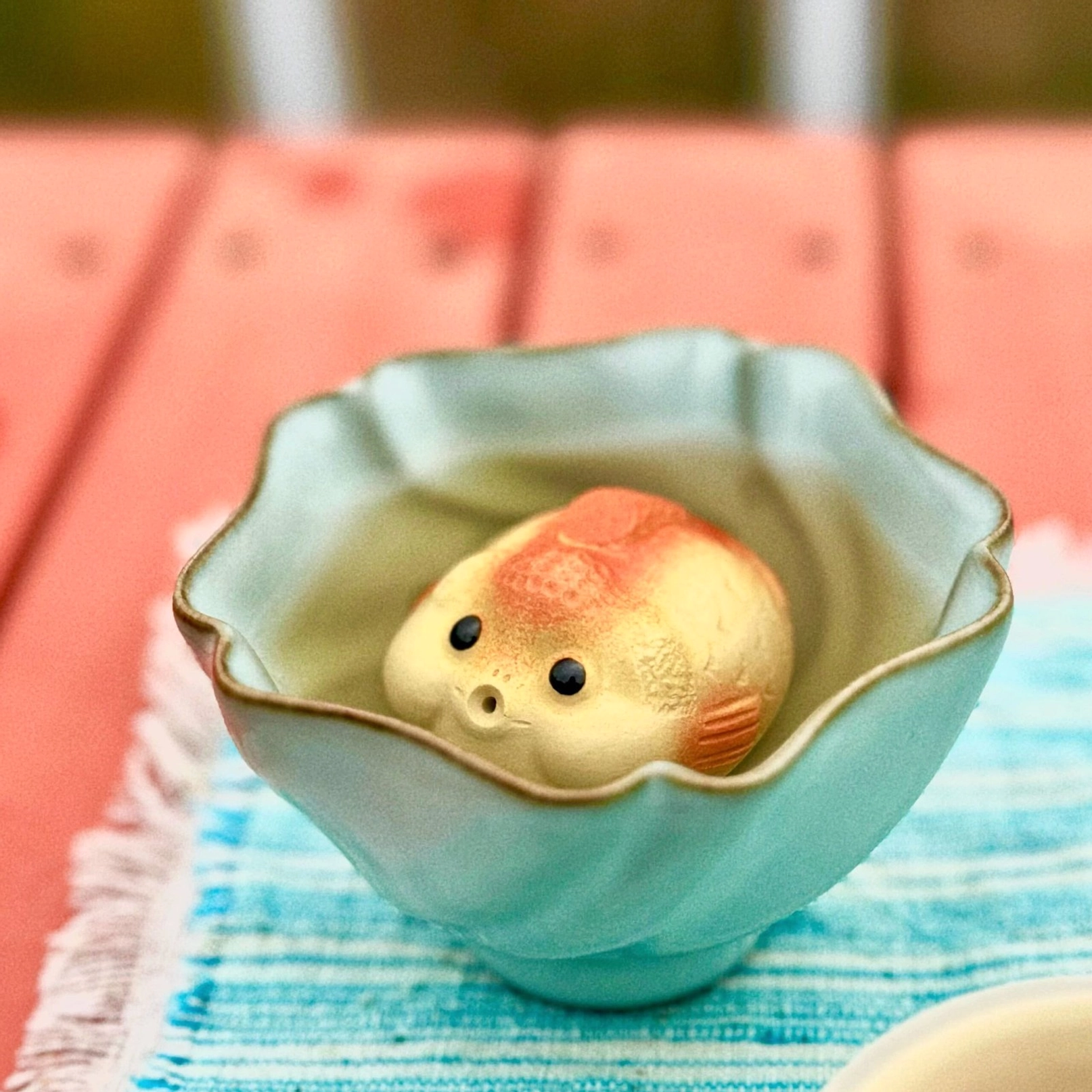 close up of hand-carved scales on lucky fish zisha tea pet