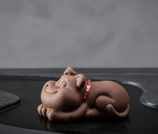 Close-up of the smiling face on the lying French bulldog puppy tea pet