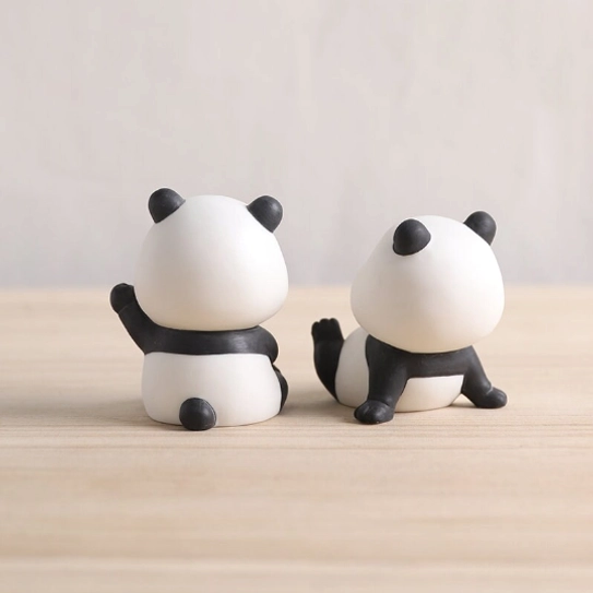 extreme closeup of hand-painted face details on kawaii ceramic panda tea pet