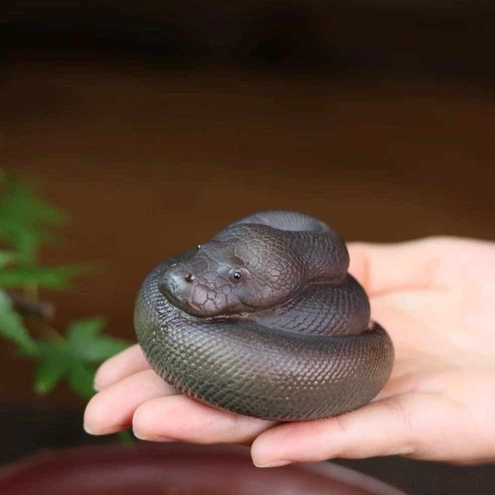 full side view of handcrafted coiled snake zisha tea pet