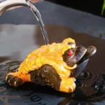 color changing lucky golden toad jin chan tea pet poured with hot water on tea tray