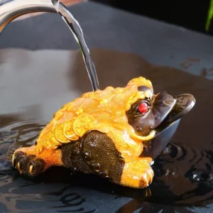 color changing lucky golden toad jin chan tea pet poured with hot water on tea tray