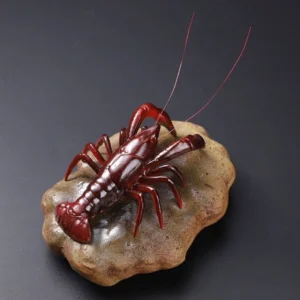 handcrafted color changing lobster ceramic tea pet on rock base
