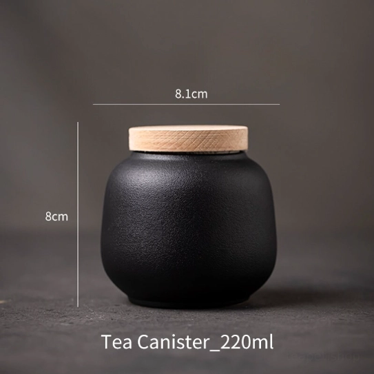 compact ceramic tea jar next to a cup of steeped tea