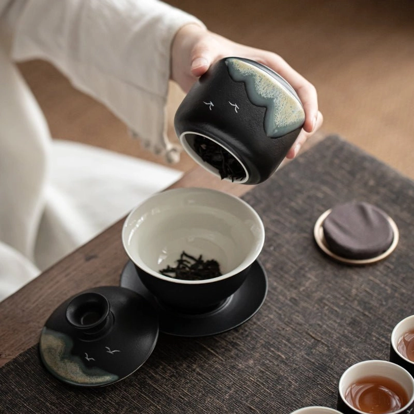 Comparison of the compact ceramic tea jar to a common tea bag to show small size