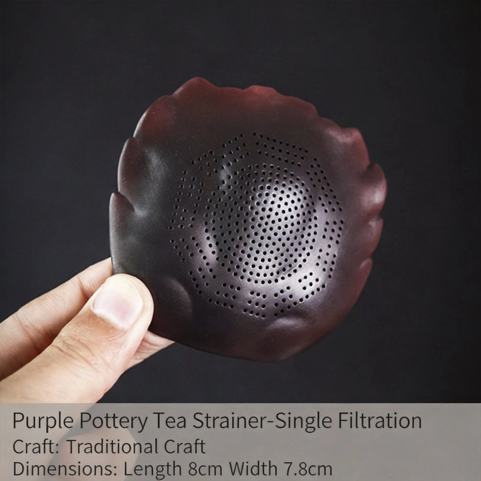 crab shell tea strainer in use filtering tea into glass cup