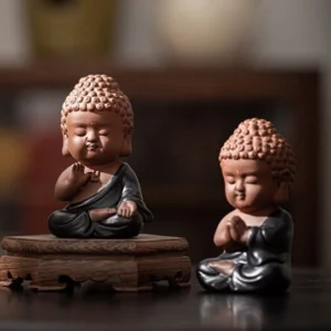 Handmade cute clay Buddha tea pet main product view on wooden tea table