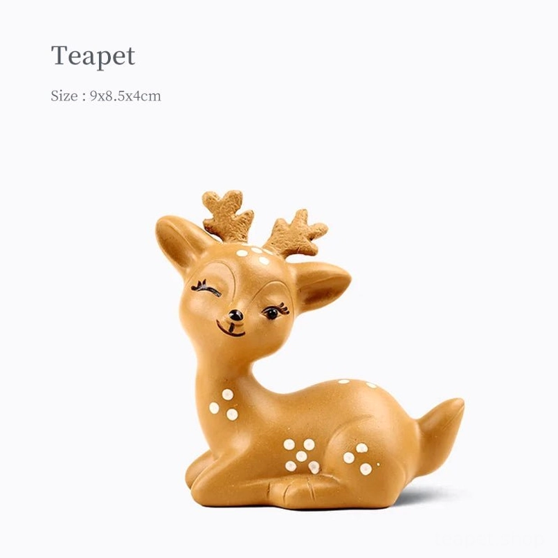 Side view of cute sika deer zisha tea pet showing spotted pattern and carved antlers