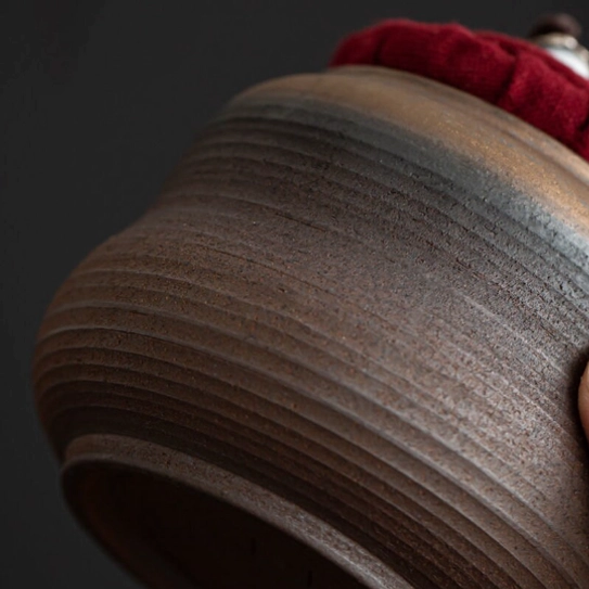 Decorative blue and white ceramic bead on tea jar cord